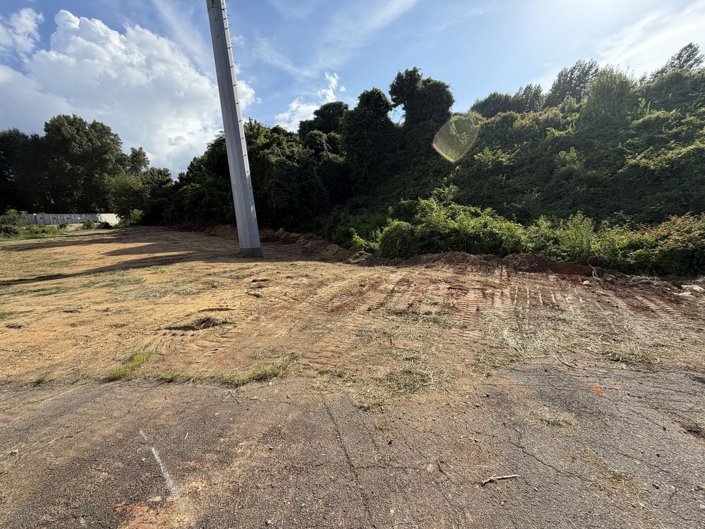 Commercial lot edge cleared back to clean asphalt