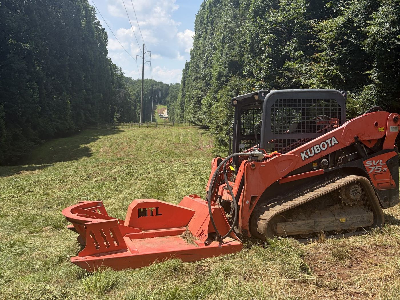 Track loader with attachment working a site in north Georgia