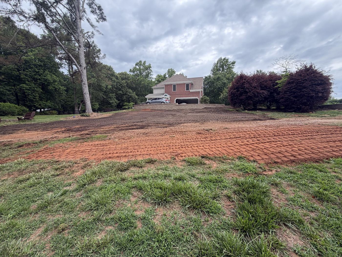 Yard graded to fresh red clay with track marks, north Georgia