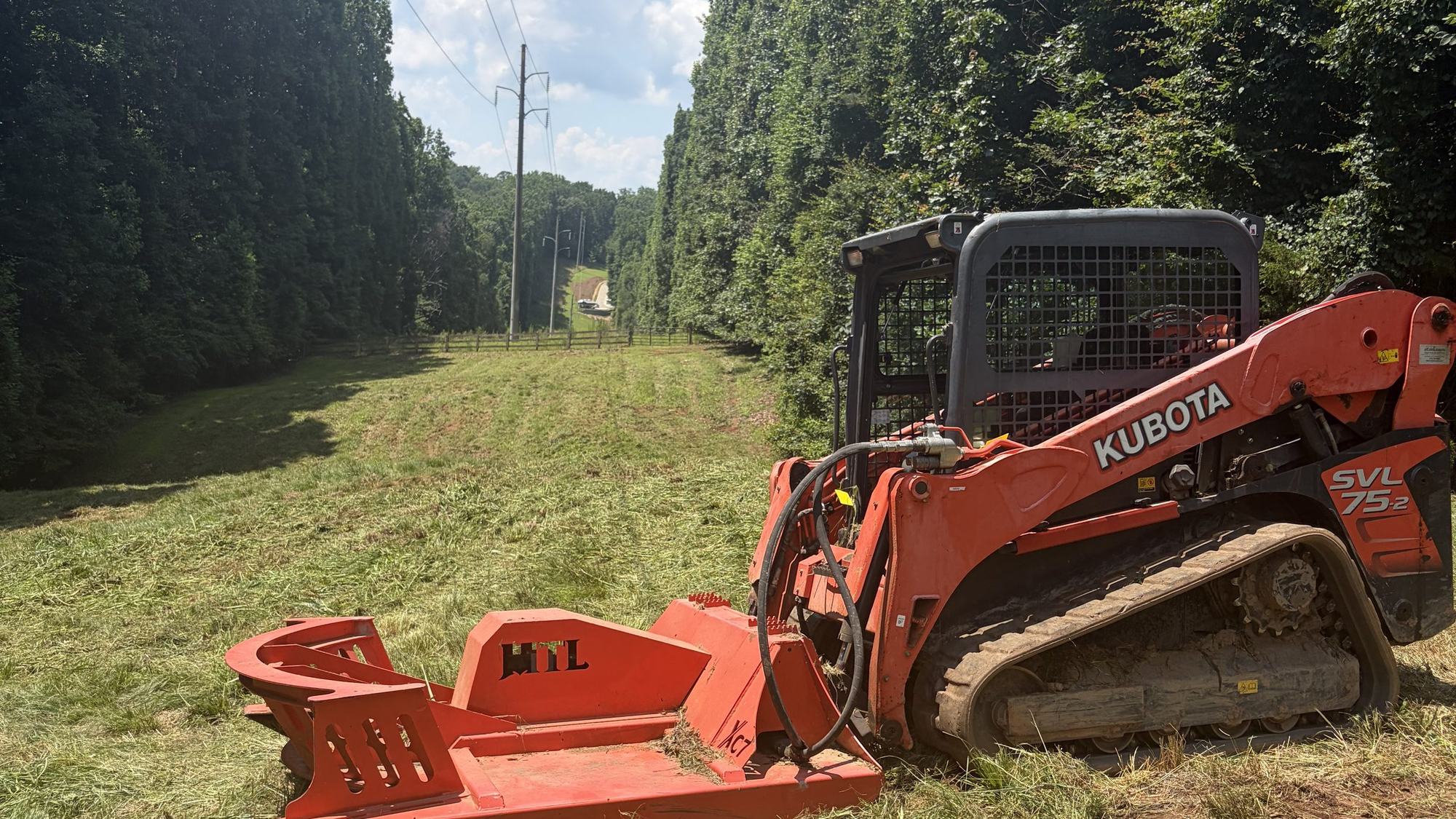 Track loader with a brush cutter attachment working a right-of-way corridor in north Georgia
